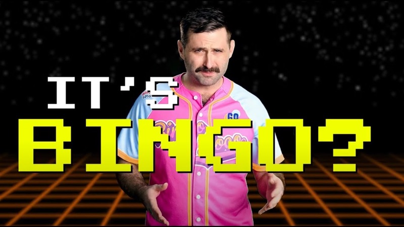 Scott Rowan on camera in a pink Bingo Loco jersey in the “What is Bingo Loco?” explainer, with the words “It’s bingo?” on screen
